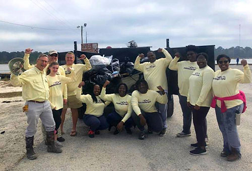 With kayaks, canoes, work gloves and one of the company’s biggest trucks – more than a dozen JubileeScape volunteers joined in a “spring cleaning” of the coastline waters of Weeks Bay.
